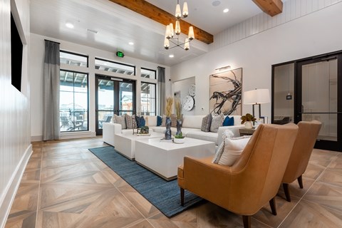 a living room with a white couch and a table with chairs